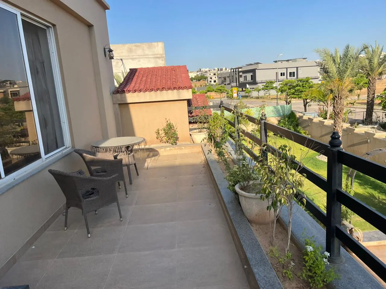 Spacious balcony overlooking the well-maintained lawn at the front door in a luxury Bahria Town house.