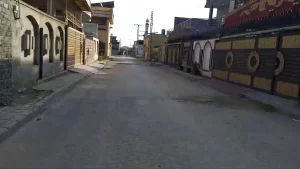 Well-paved street with residential homes in Kainat Housing Colony, Rawalpindi.