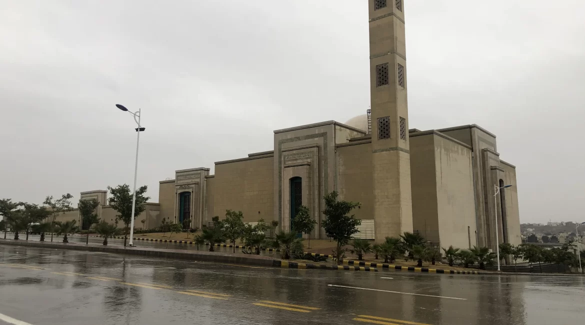 Large mosque with tall minaret on a rainy day in Sector C Phase 8 Bahria Town