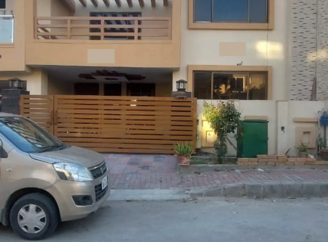 House for sale Umar Block – modern façade with wooden gate, balcony and parked car