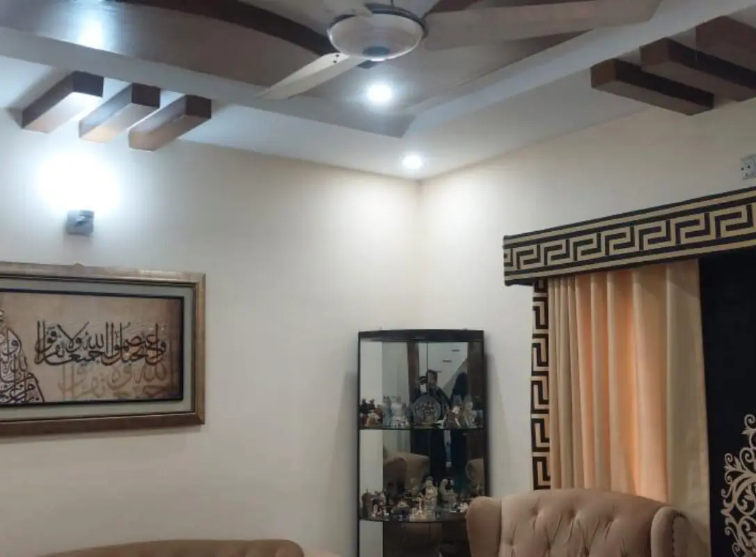 House for sale Umar Block – lounge wall with calligraphy art, display cabinet and ceiling beams